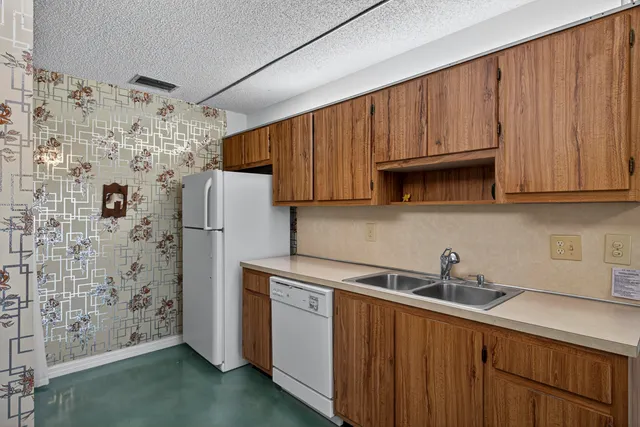 a kitchen with stainless steel appliances a refrigerator and a sink