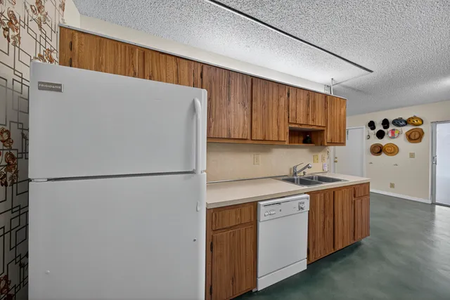 a utility room with cabinets washer and dryer