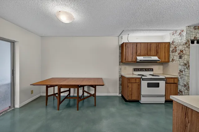 a kitchen with stainless steel appliances a stove a sink and a refrigerator