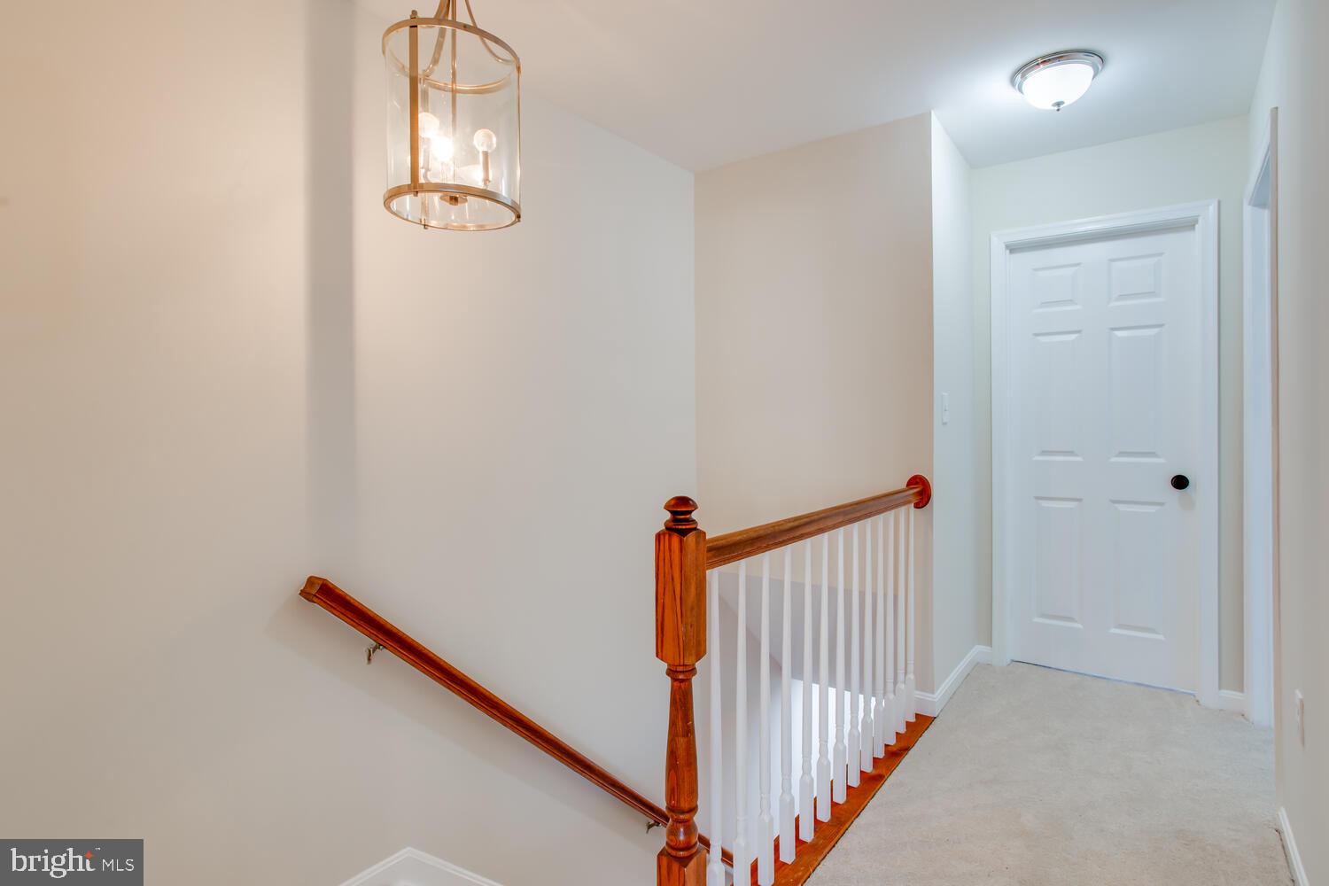 7024 Commander Howe Terrace Brandywine, MD 20613 - Photo 15 of 34 a view of a hallway with wooden floor and staircase