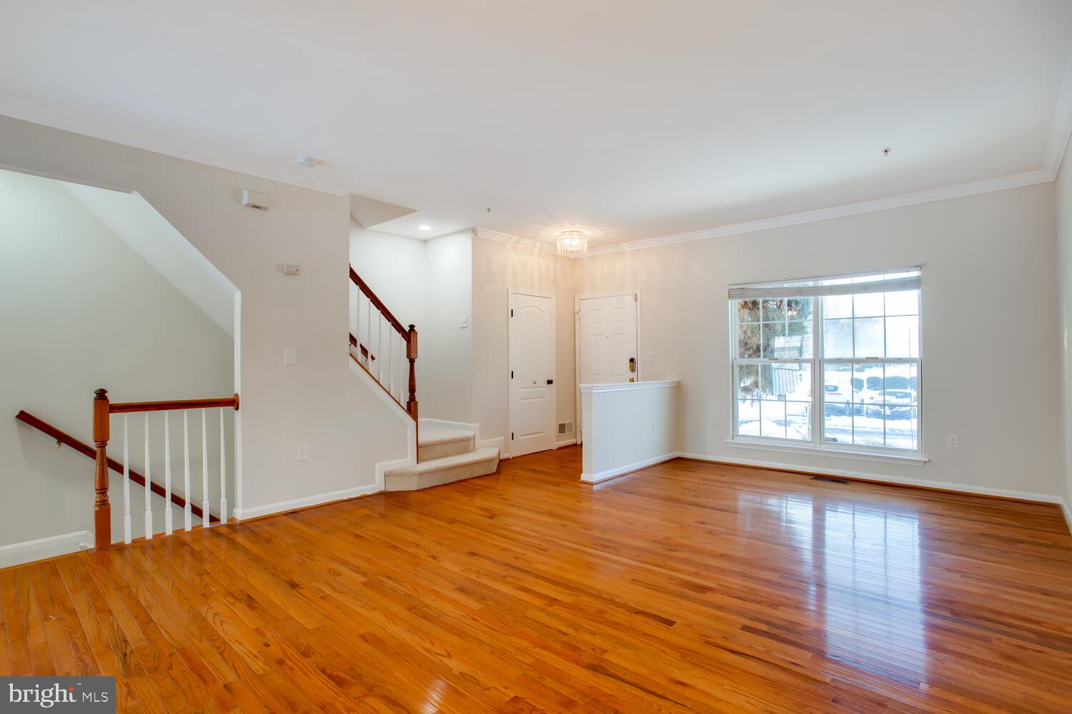 7024 Commander Howe Terrace Brandywine, MD 20613 - Photo 2 of 34 a view of an empty room with wooden floor and a window