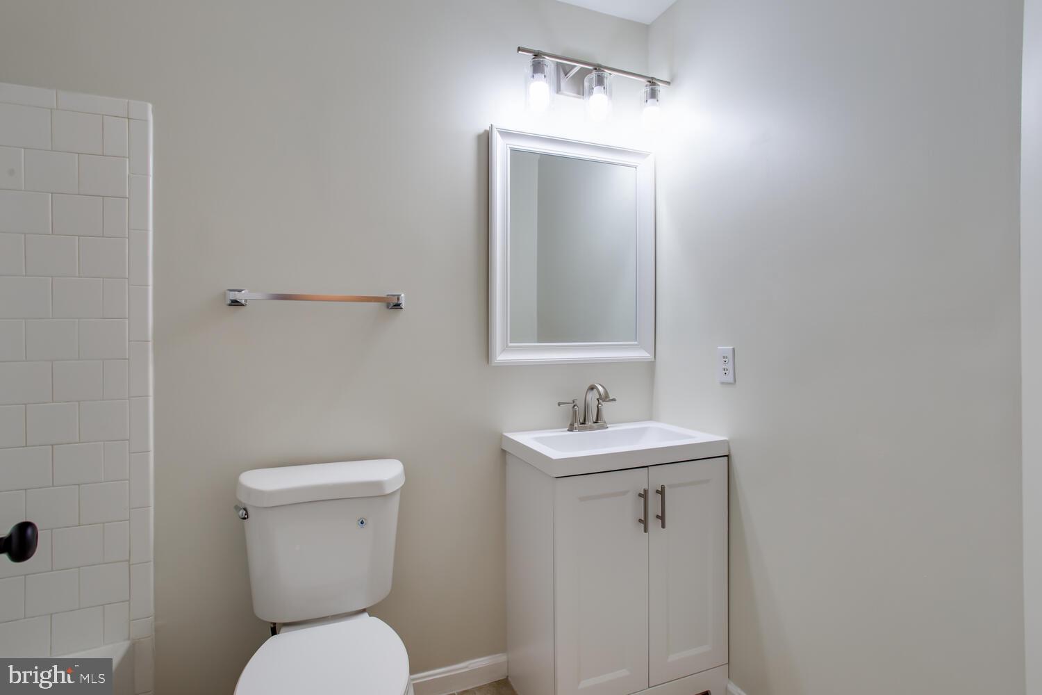 7024 Commander Howe Terrace Brandywine, MD 20613 - Photo 27 of 34 a bathroom with a toilet a sink and mirror