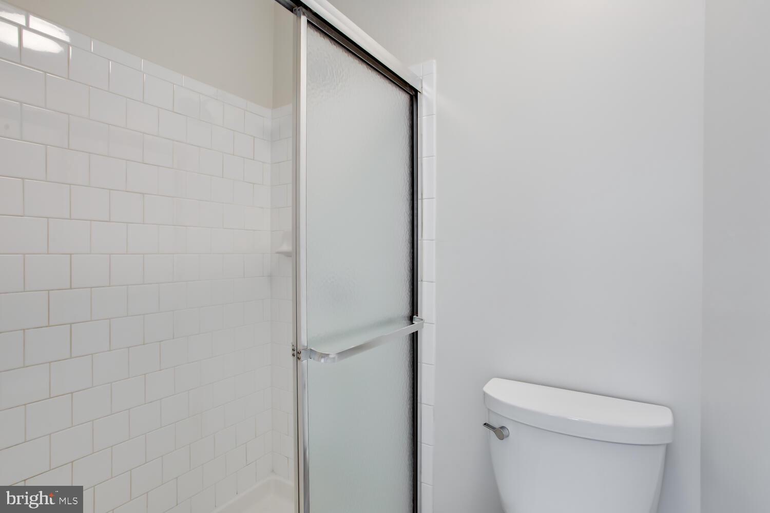 7024 Commander Howe Terrace Brandywine, MD 20613 - Photo 29 of 34 a bathroom with a white toilet and a shower