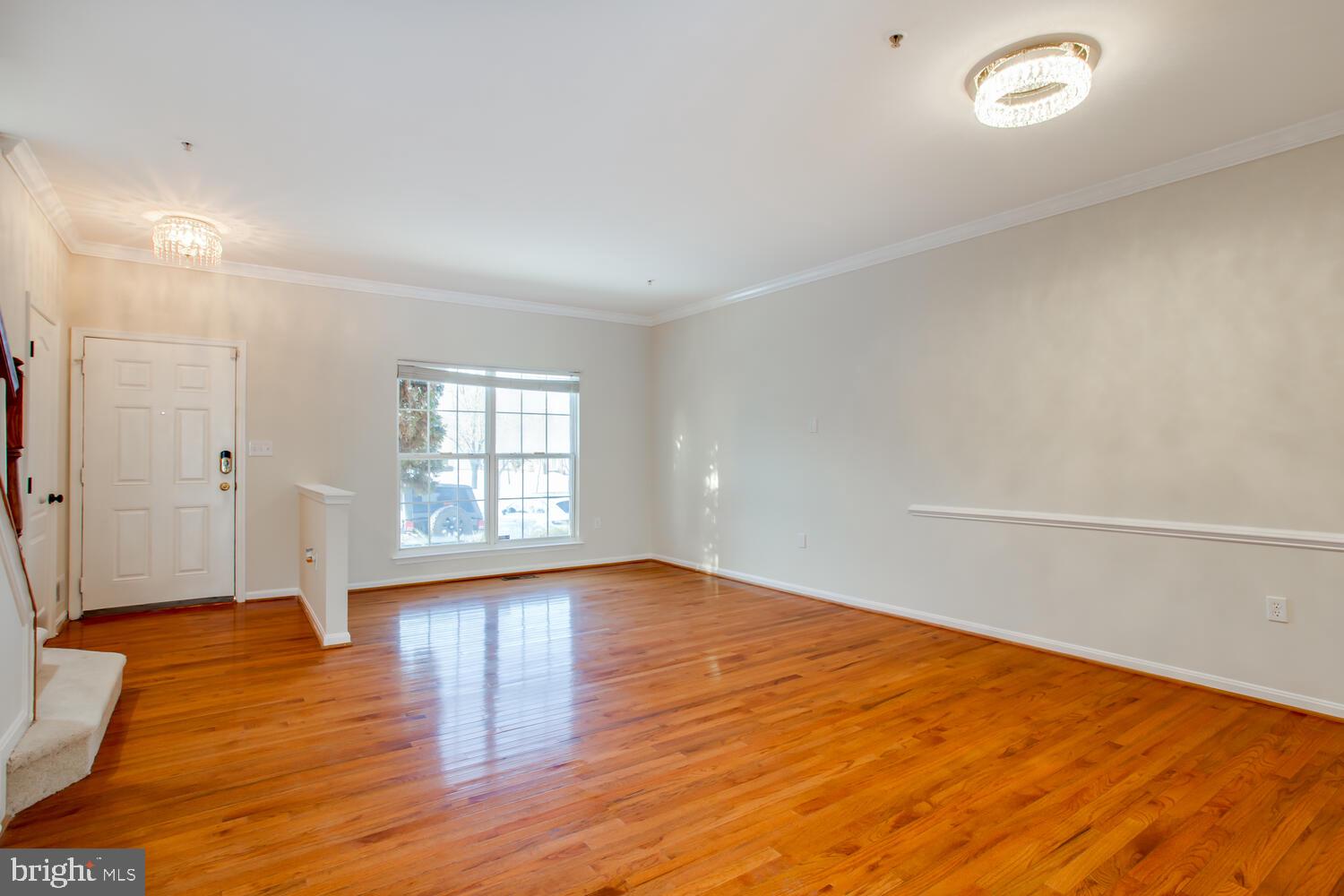 7024 Commander Howe Terrace Brandywine, MD 20613 - Photo 3 of 34 a view of an empty room with wooden floor and a window