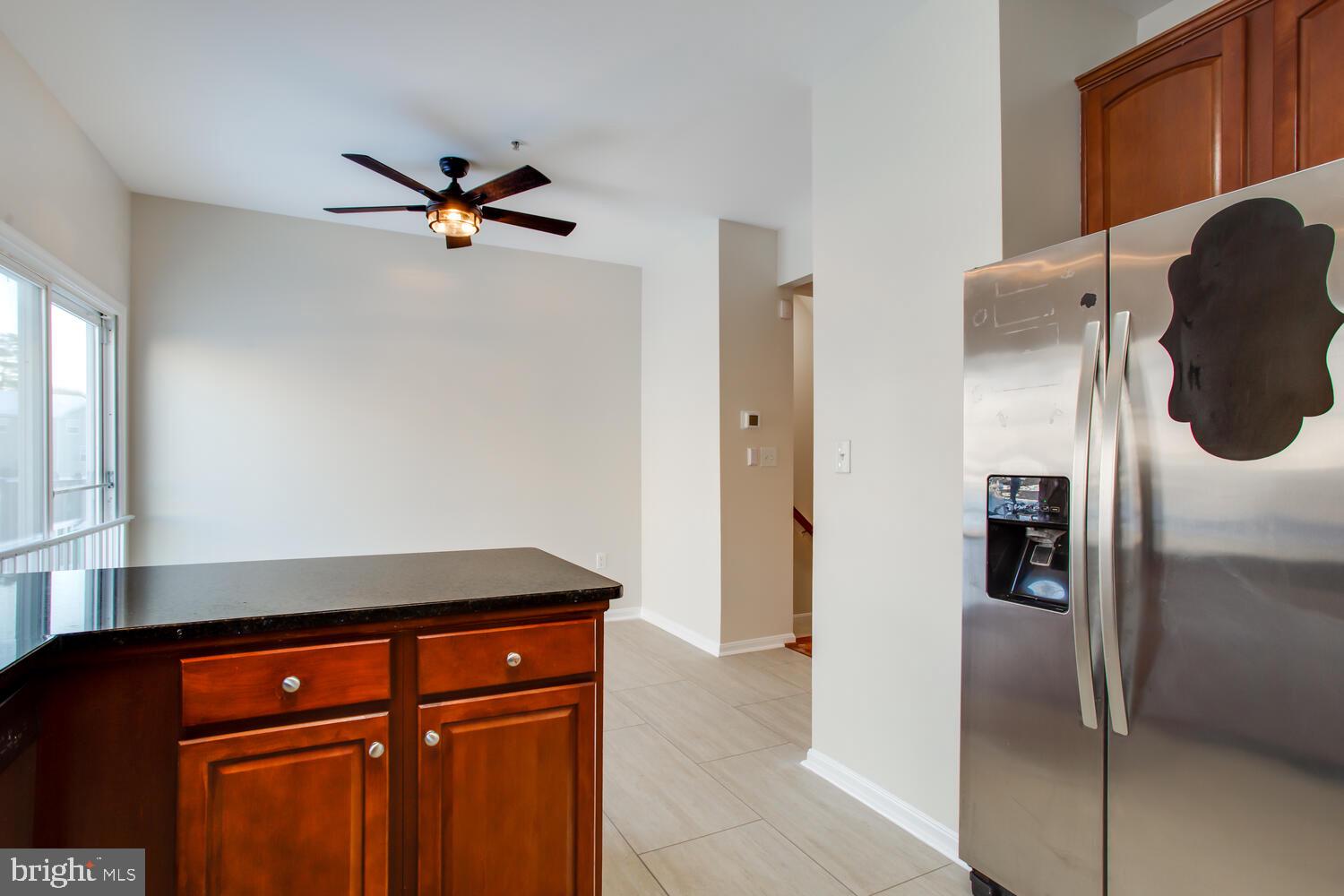 7024 Commander Howe Terrace Brandywine, MD 20613 - Photo 9 of 34 a close view of a refrigerator in kitchen and an empty room