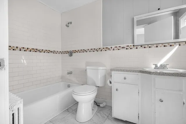 a bathroom with a toilet a sink and bathtub