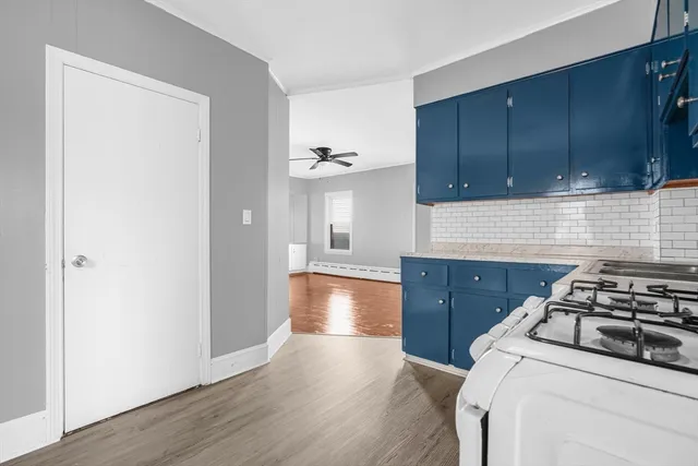 a kitchen with granite countertop a stove and a wooden cabinets