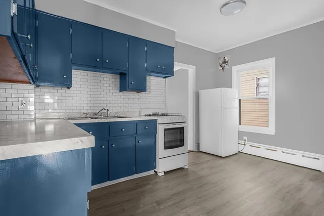a kitchen with a refrigerator sink and cabinets