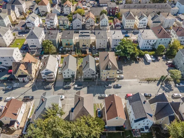 an aerial view of residential houses with outdoor space