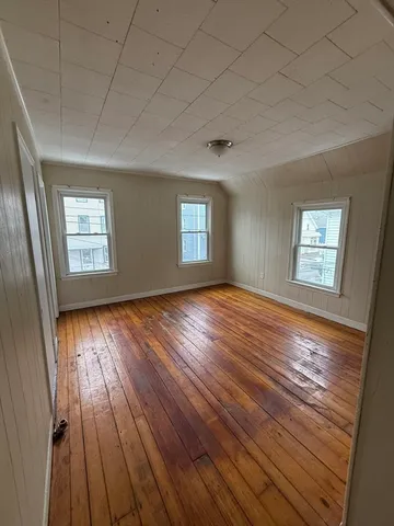 en empty room with window and mirror