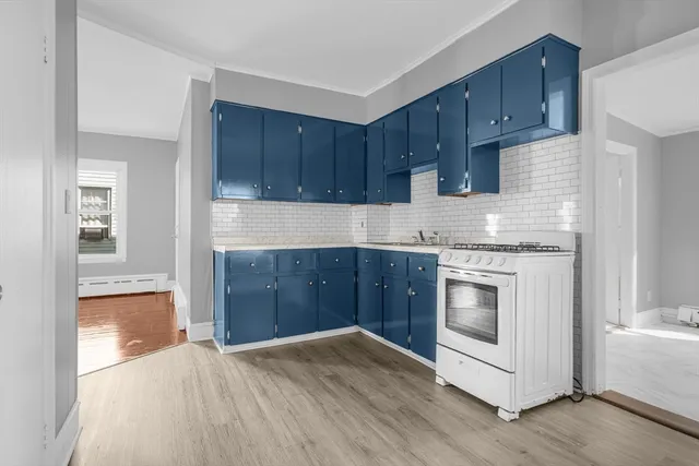 a kitchen with granite countertop wooden cabinets and white appliances