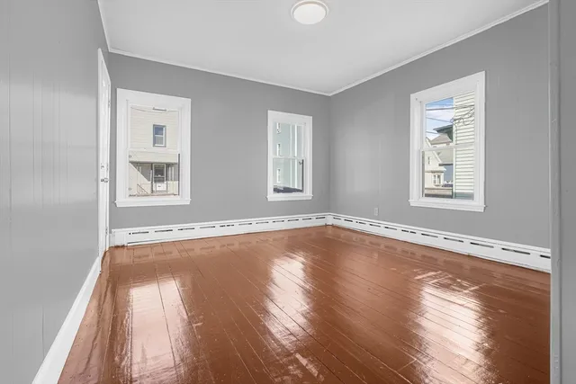 a view of a room with wooden floor and windows