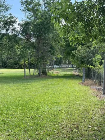 a view of a swimming pool with a yard
