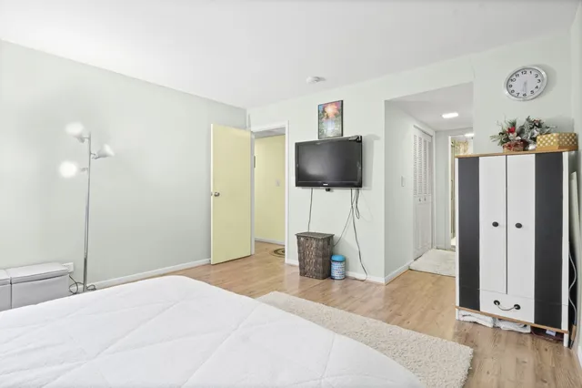 a bedroom with a bed and a flat screen tv