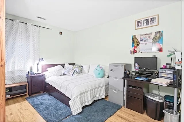 a bedroom with a bed and a couch