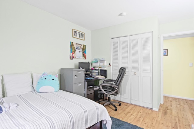 4704 Euclid Avenue, Unit 1B Rolling Meadows, IL 60008 - Photo 15 of 20 a bedroom with a bed a desk and chair with wooden floor
