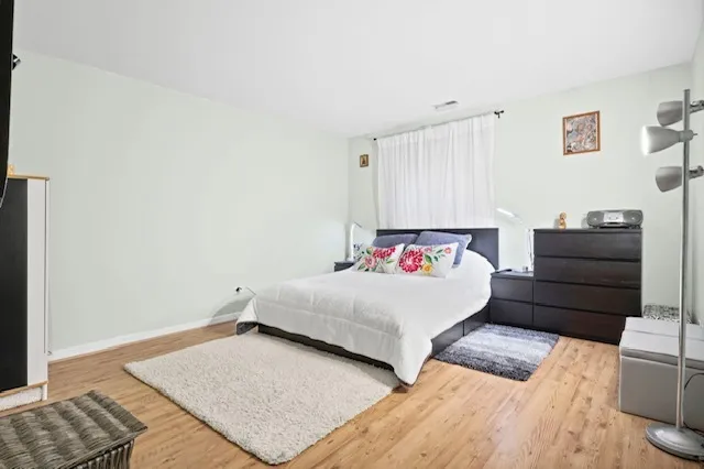 a bedroom with a bed and a couch