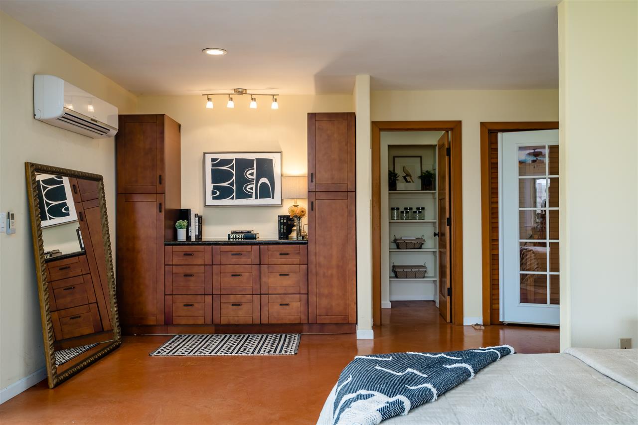 3175 Ua Noe Place, Unit A Haiku, HI 96708 - Photo 25 of 29 a spacious bedroom with a bed and a dresser in it
