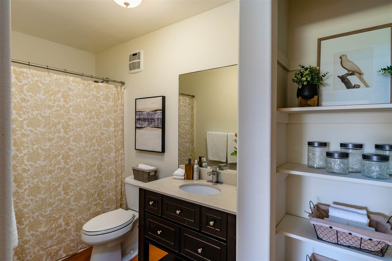 3175 Ua Noe Place, Unit A Haiku, HI 96708 - Photo 26 of 29 a bathroom with a granite countertop sink toilet and a mirror