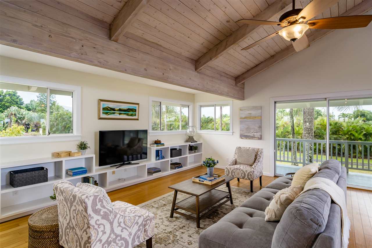 3175 Ua Noe Place, Unit A Haiku, HI 96708 - Photo 3 of 29 a living room with furniture a fireplace and a flat screen tv