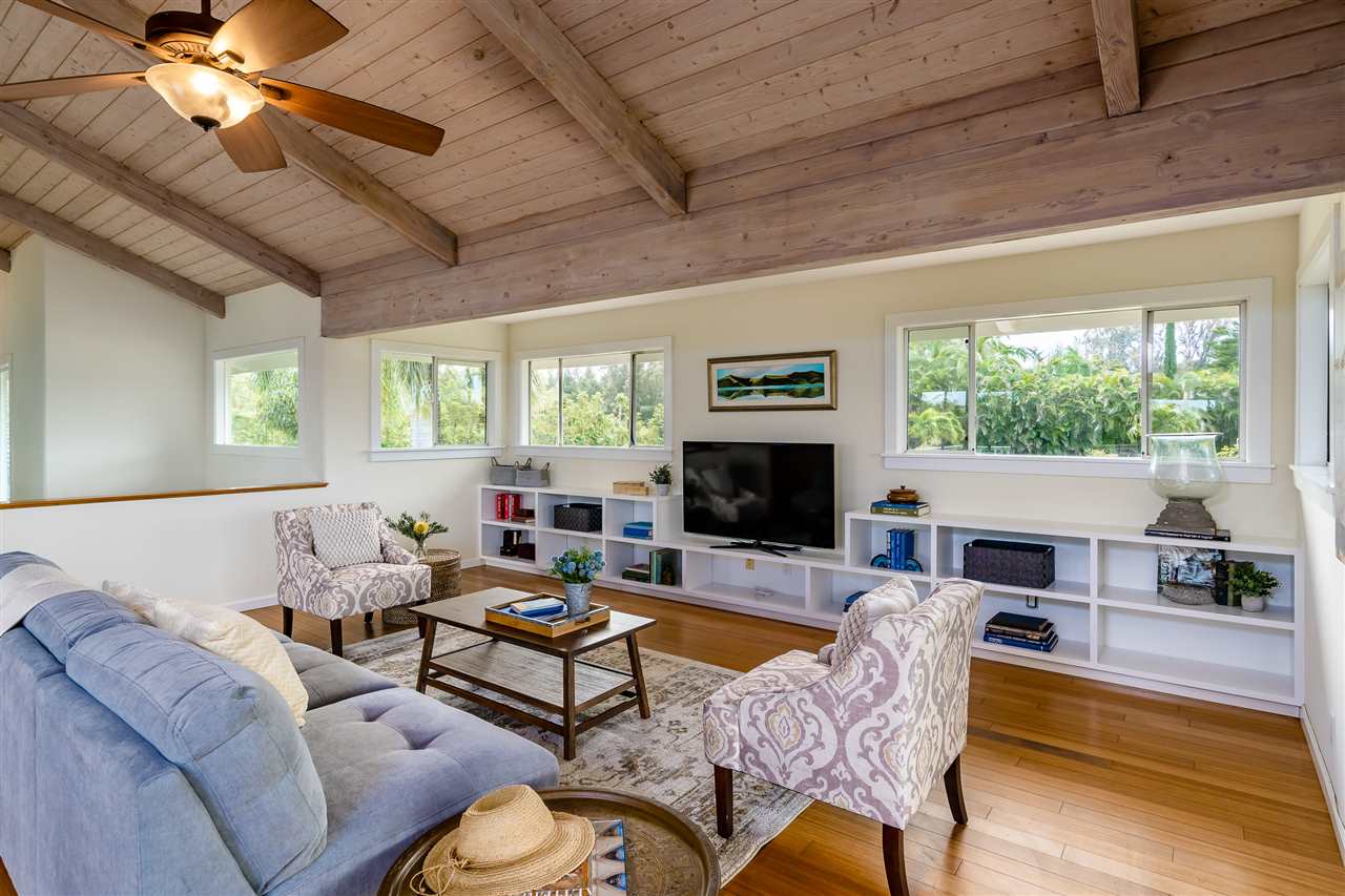 3175 Ua Noe Place, Unit A Haiku, HI 96708 - Photo 5 of 29 a living room with furniture a fireplace and a flat screen tv