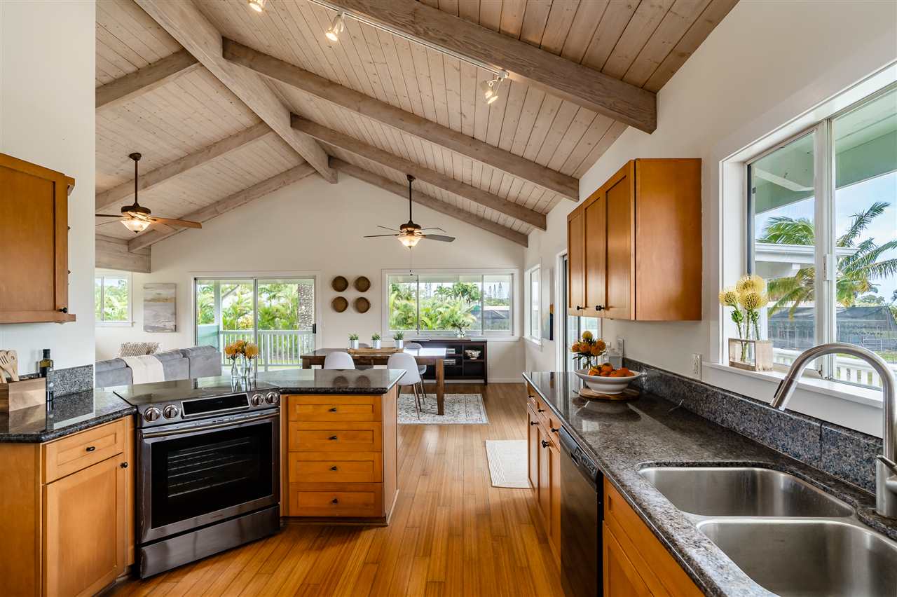 3175 Ua Noe Place, Unit A Haiku, HI 96708 - Photo 8 of 29 a kitchen with lots of counter top space and wooden floor