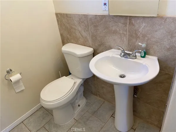 a white toilet sitting next to a bathroom sink
