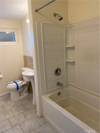 a bathroom with a sink toilet and bathtub