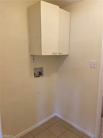 a view of storage and utility room with wooden floor