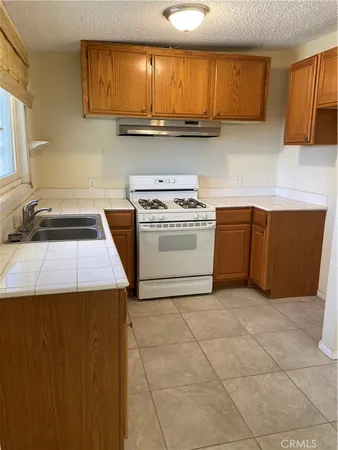 a kitchen with a stove a sink and a microwave