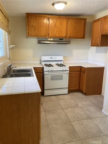 a kitchen with a stove a sink and a microwave