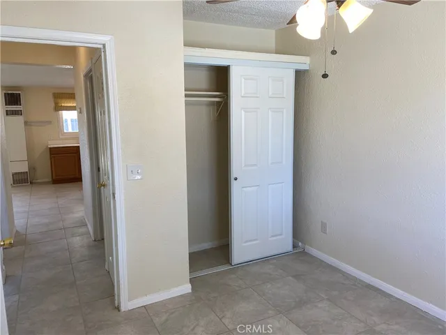 an empty room and a bathroom with mirror