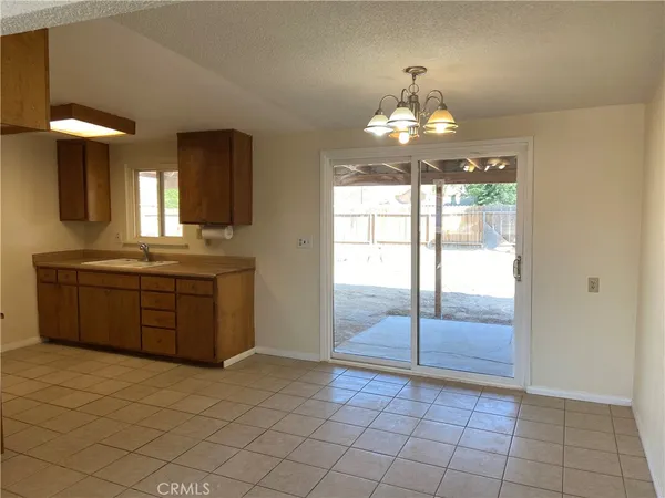 a view of a kitchen with a sink and chandelier