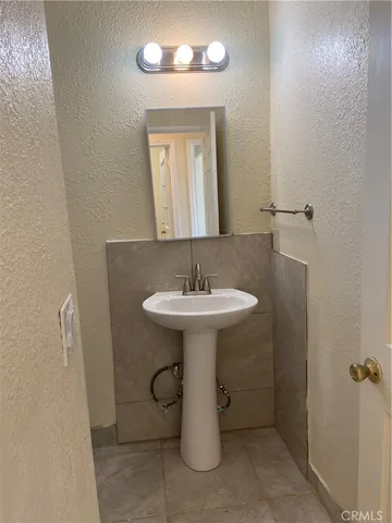 a bathroom with a sink a mirror and shower