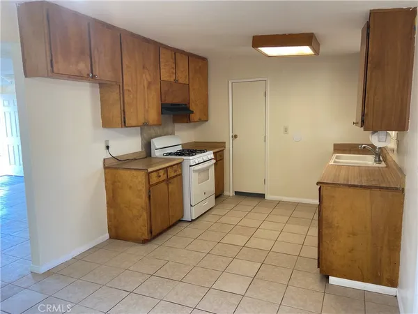 a kitchen with a sink cabinets and appliances