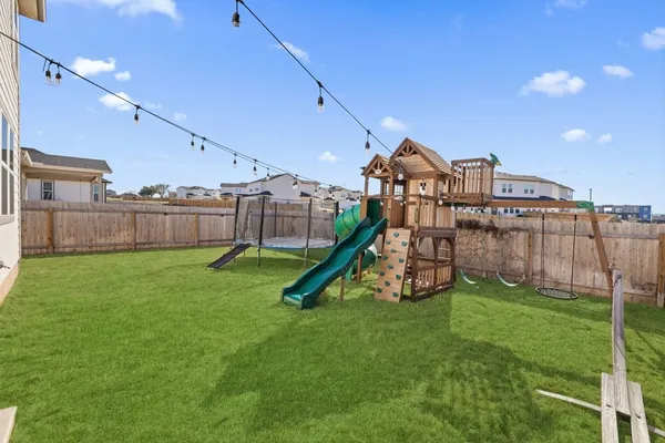 a view of a house with a backyard and a slide