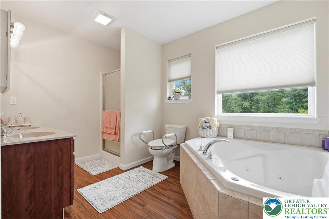 5032 Custard Road Stroudsburg, PA 18360 - Photo 37 of 80 Warm wood flooring and a deep soaking tub anchor this inviting bath space.
