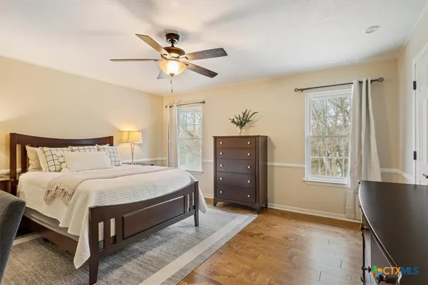 a spacious bedroom with a bed and a table in it