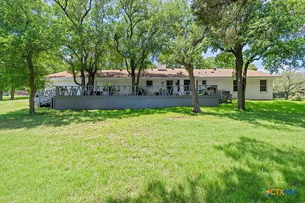 a view of a house with a yard and sitting area