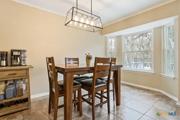 a kitchen with stainless steel appliances kitchen island granite countertop a refrigerator and cabinets