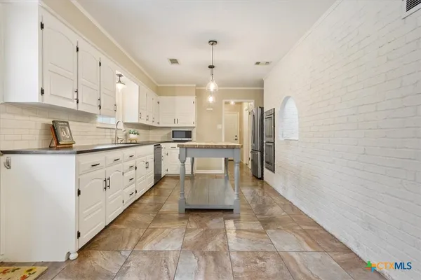 a view of empty room with a fireplace and wooden floor