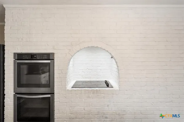 a kitchen with granite countertop white cabinets white appliances and a sink