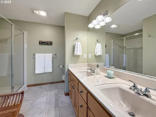 a bathroom with a sink double vanity granite and a mirror