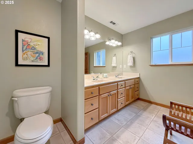 a spacious bathroom with a toilet sink and mirror