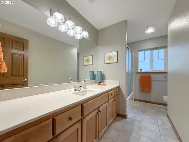 a spacious bathroom with a sink a mirror and a shower