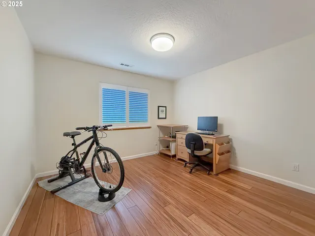 a view of a workspace with furniture and a window