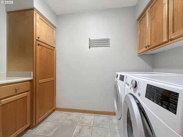 a view of a storage and utility room with washer and dryer