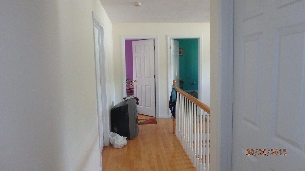 11 Saffron Drive Worcester, MA 01605 - Photo 7 of 9 a view of a hallway with wooden floor and stairs