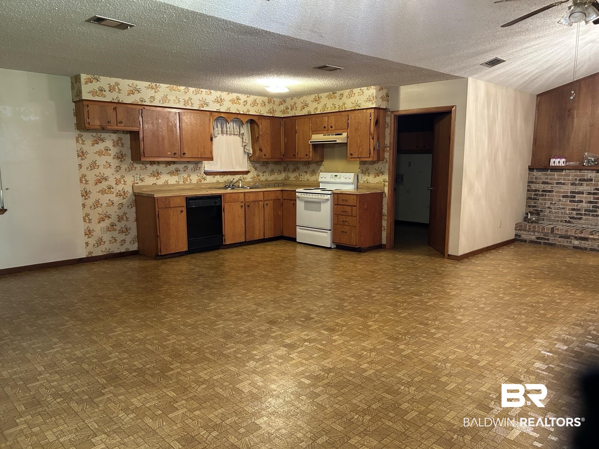 1350 A Schillinger Road South Mobile, AL 36695 - Photo 3 of 18 Kitchen with electric range, black dishwasher, under cabinet range hood, light countertops, and ceiling fan