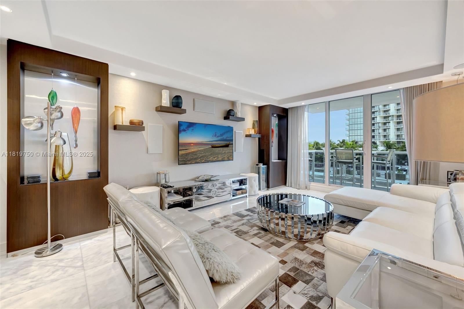 2301 Collins Avenue, Unit 307 Miami Beach, FL 33139 - Photo 1 of 17 a living room with furniture and a flat screen tv
